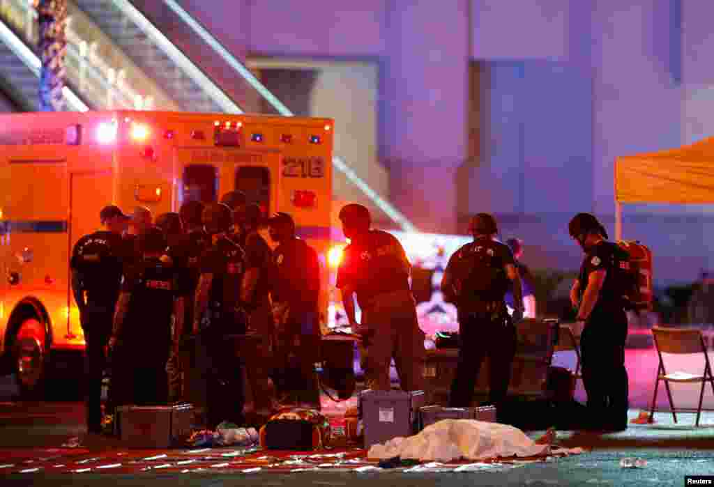 A body is covered with a sheet in the intersection of Tropicana Avenue and Las Vegas Boulevard South after a mass shooting at a music festival on the Las Vegas Strip in Las Vegas, Nevada, Oct. 1, 2017.