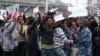 A policeman attempts to control protesters chanting slogans during a demonstration over what they say is unfair distribution of wealth in the country at Meskel Square in Ethiopia's capital Addis Ababa, Aug. 6, 2016.