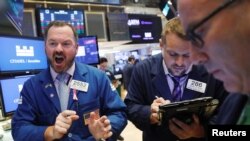 Traders work on the floor of the New York Stock Exchange shortly after the opening bell in New York, July 23, 2018. 