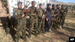 This photo released in a statement by the Pakistani Taliban shows the fighters who stormed a military-run school in Peshawar, Pakistan, Dec. 16, 2014.