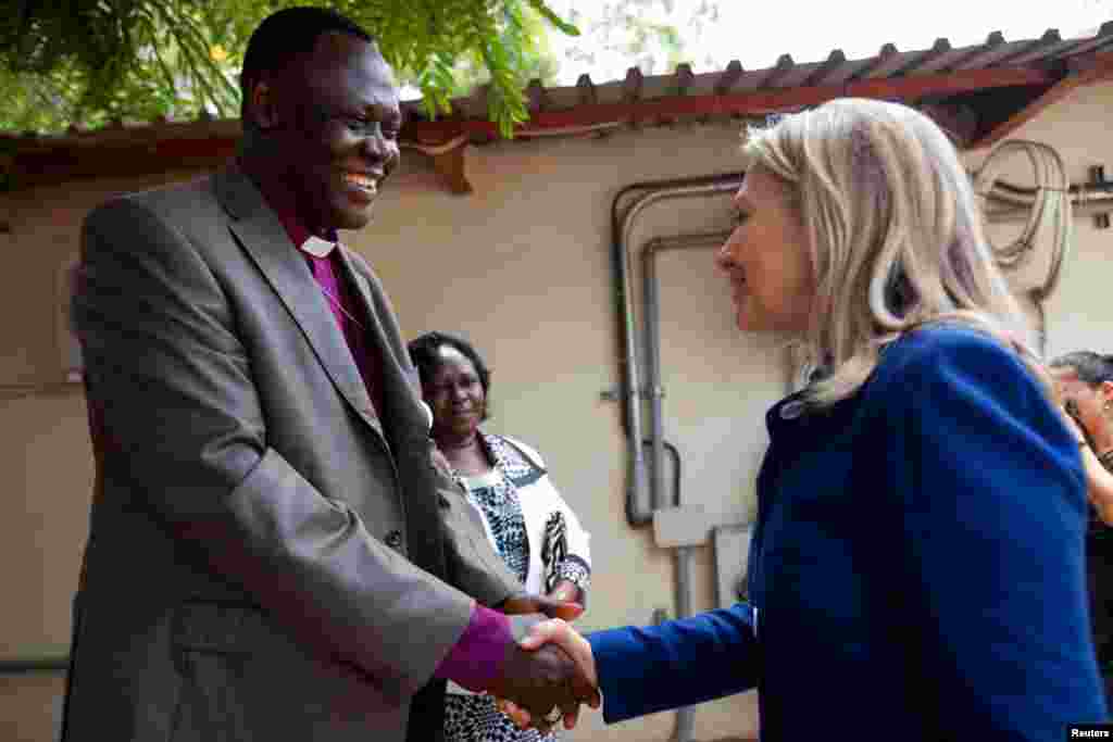 Hillary Clinton shakes hands with Bishop Elias Taban in Juba August 3, 2012. 
