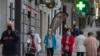 Des personnes portant des masques faciaux pour se protéger contre le coronavirus marchent dans les rues de Madrid, Espagne, le 13 mai 2020.