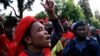 Members of the Economic Freedom Fighters (EFF) party sing during their march for economic reform outside the Johannesburg Stock Exchange, Oct. 27, 2015.