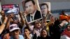 Supporters of former Egyptian President Hosni Mubarak hold his posters and a poster of Egyptian Army Chief Lt. Gen. Abdel-Fattah el-Sissi, left, in front of Tora prison in Cairo, Aug. 22, 2013.