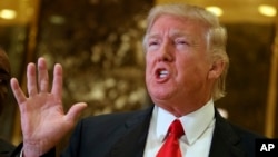 President-elect Donald Trump speaks with reporters in the lobby of Trump Tower in New York. Trump has offered views on U.S. relations with Asia that could indicate radical shifts in long-standing policy toward the region.