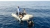 ATTENTION EDITORS - VISUAL COVERAGE OF SCENES OF INJURY OR DEATHMembers of Libya's coast guard recover the body of a migrant who drowned off Tripoli's coast, August 23, 2014. A wooden boat carrying up to 200 migrants has sunk just one kilometre (half a mi