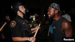 A man confronts police outside the Kenosha Police Department in Kenosha, Wisconsin, U.S., during protests following the police shooting of Black man Jacob Blake August 23, 2020.