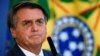 El expresidente de Brasil, Jair Bolsonaro, observa durante la ceremonia de lanzamiento de la Tarjeta Nacional de Identidad en el Palacio Planalto en Brasilia, el 23 de febrero de 2022. 
