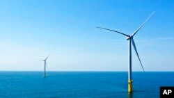 FILE - Part of the offshore wind farm that has been built off the coast of Virginia Beach, Virginia on June 29, 2020. (AP Photo/Steve Helber, File)