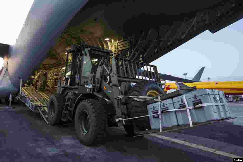 A vehicle is unloaded from an U.S. Air Force C-17A Globemaster III aircraft after it landed at Tribhuvan International in Kathmandu, Nepal, May 5, 2015.