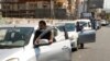 People push their cars due to a lack of fuel, near a gas station in Dora, Lebanon, Aug. 17, 2021. 