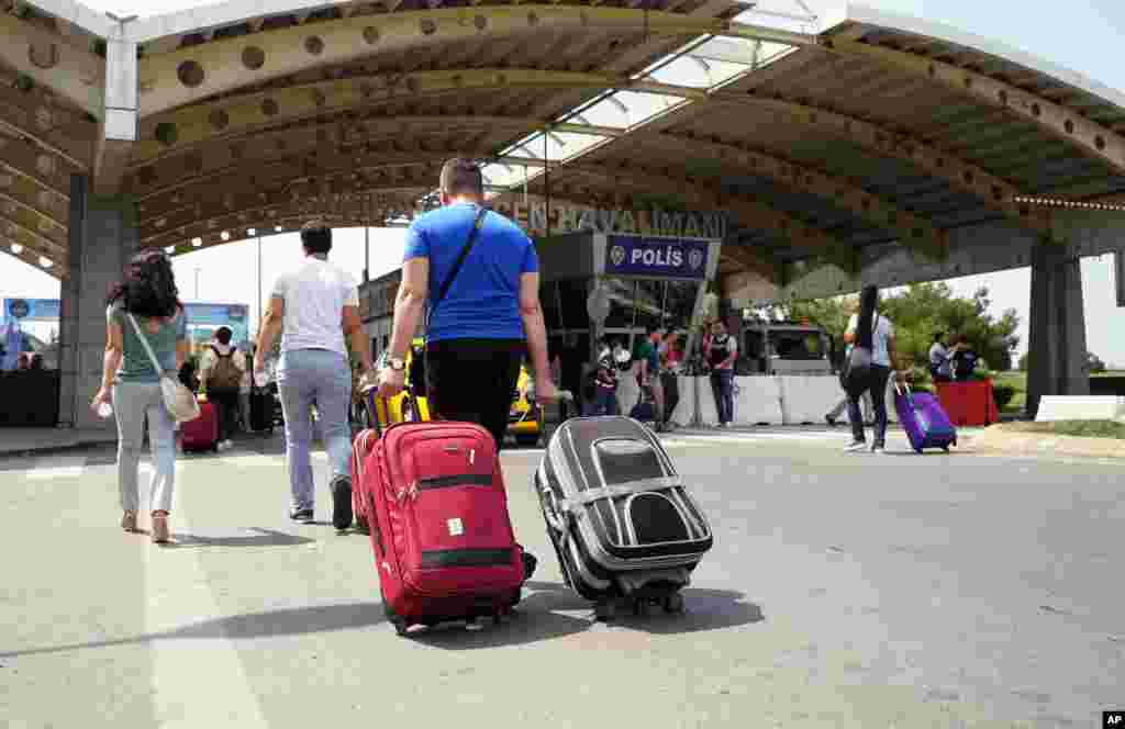 Passengers pull their bags as they arrive at Sabiha Gokcen Airport, in Istanbul, July 17, 2016.&nbsp;Rather than toppling the country&#39;s strongman president, a failed military coup appears to have bolstered Recep Tayyip Erdogan&#39;s immediate grip on power and boosted his popularity.&nbsp;