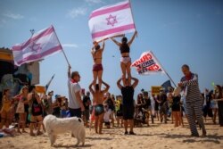 FILE - People protest against the government's decision to close beaches during the three-week nationwide lockdown due to the coronavirus pandemic, in Tel Aviv, Israel, Sept 19, 2020.