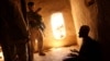 FILE - U.S. Army soldier and an Afghan translator interrogate a person in the Bagh village of Khakeran Valley, Zabul province, Afghanistan.