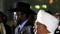 Sudanese President Omar al-Bashir (R) listens as his South Sudanese counterpart Salva Kiir speaks during a joint news conference, before Kiir's departure at Khartoum Airport, October 9, 2011.