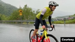 Farid Noori, who came to the U.S. in 2011, and now teaches students in Afghanistan remotely, bikes Whiteface Mountain in the New York Adirondacks. (Courtesy - Ian Lynch) 