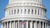 USA, Washington, The American Flag flies at the U.S. Capitol Building