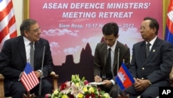 U.S. Defense Secretary Leon Panetta, left, speaks with Cambodian Defense Minister Tea Banh, right, in Siem Reap, Cambodia, November 16, 2012.