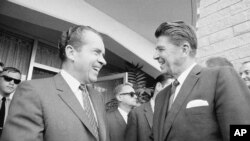  FILE - Richard Nixon greets California Gov. Ronald Reagan (R) in San Diego on Aug. 16, 1968, before conferring about their campaign plans.