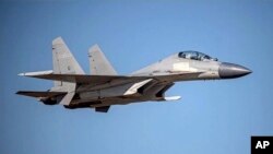 FILE - In this undated file photo released by the Taiwan Ministry of Defense, a Chinese PLA J-16 fighter jet flies in an undisclosed location. 