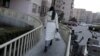 A women is seen walking toward her apartment building in Beijing, Feb. 10, 2015. An emotional video ad about “leftover women” in China has gone viral, uncovering the society’s deep-rooted discrimination against single women.