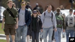 FILE - Students walk across campus at the University of Vermont in Burlington, Vt.