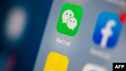 This illustration picture taken on July 24, 2019, in Paris shows the logo of the Chinese instant messaging application WeChat on the screen of a tablet. 
