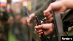 FILE - Revolutionary Armed Forces of Colombia (FARC) fighters participate in a parade in the Villa Colombia camp near San Vicente del Caguan, Caqueta province, Colombia, April 29, 2000.