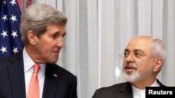U.S. Secretary of State John Kerry, left, and Iran's Foreign Minister Mohammad Javad Zarif are seen before resuming talks over Iran's nuclear programme in Lausanne, Switzerland, March 16, 2015. 