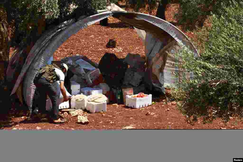 A Free Syrian Army member inspects goods that were confiscated at a checkpoint during a siege on the Kurdish city of Afrin, which is under the control of the Kurdistan Workers&#39; Party (PKK), in the Aleppo countryside June 30, 2013.