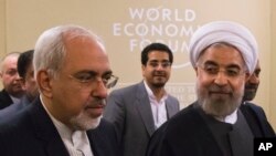Iran's President Hassan Rouhani (r), and and his Foreign Minister Mohammad Javad Zarif, at the World Economic Forum in Davos, Jan. 22, 2014. 