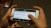 A user explores “Cambodian Voter’s Voice”, a new mobile app developed by Cambodia's election watchdog COMFREL, on August 27, 2015. (Hean Socheata/VOA Khmer) 