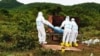FILE - Health workers prepare to cremate the body of a COVID-19 patient in Kampong Trach District of Cambodia's southwestern Kampot province in June 2021. (Facebook/Kampot Provincial Police Department)