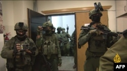 An image grab from footage distributed by the Doha-based Al-Jazeera TV on September 22, 2024 shows Israeli soldiers entering Al Jazeera's office in Ramallah, in the West Bank to issue a 45-day closure order on September 21.