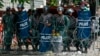 Cambodian riot police officers stand guard behind barbed wire as they block entry to Freedom Park, in Phnom Penh, Cambodia, July 15, 2014. 