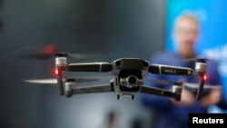 FILE - A DJI Mavic 2 Zoom flies in a netted area during the 2019 CES in Las Vegas, Nevada, Jan. 9, 2019. 