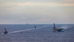 FILE - Japan Maritime Self-Defense Force training ships JS Kashima and JS Shimayuki conduct a passing exercise (PASSEX) with Nimitz-class nuclear-powered aircraft carrier USS Ronald Reagan in the South China Sea, July 7, 2020.