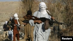 FILE - Armed Taliban fighters are seen at an undisclosed location in Nangarhar province, Afghanistan, Dec.13, 2010. 