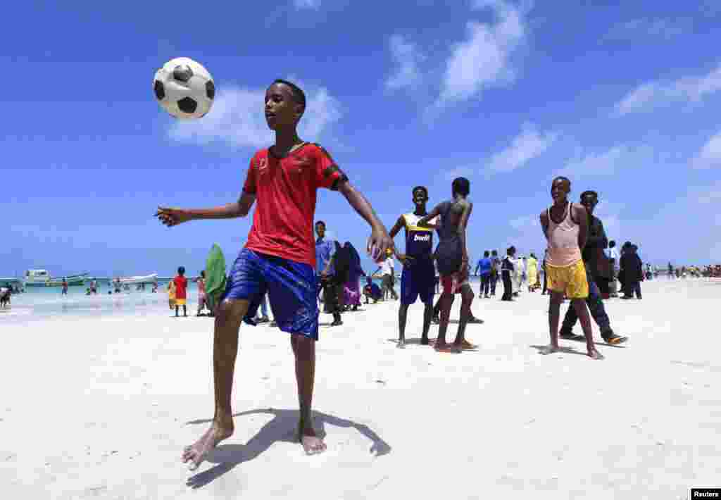 Somali boys play football in Lido beach while celebrating the Muslim Eid al-Fitr holiday, in the capital, Mogadishu, August 8, 2013.&nbsp;