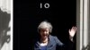 Britain's new Prime Minister Theresa May waves as she leaves after a Cabinet meeting at number 10 Downing Street in central London on July 12, 2016. 