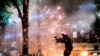 A federal officer fires crowd control munitions at protesters at the Mark O. Hatfield United States Courthouse on July 24, 2020, in Portland, Ore. 