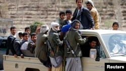 Houthi fighters ride a patrol truck in Sana'a, Yemen, March 5, 2015.