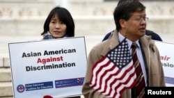 FILE - Asian-American demonstrators hold a rally outside the U.S. Supreme Court as it was hearing a case involving affirmative action in university admissions, Dec. 9, 2015. (REUTERS/Kevin Lamarque)