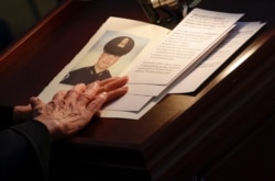 FILE - A photo of U.S. Capitol Police officer Brian Sicknick is seen during a memorial ceremony, at the Capitol, in Washington, Feb. 3, 2021.