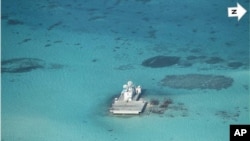 In this photo taken Feb. 28, 2013 by a surveillance plane, and released Thursday, May 15, 2014, by the Philippine Department of Foreign Affairs, Chinese-made structures stands on the Johnson Reef, called Mabini by the Philippines and Chigua by China, in t