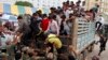 Cambodian migrant workers get off from a Thai truck upon their arrival from Thailand at a Cambodia-Thai international border gate in Poipet, Cambodia, Tuesday, June 17, 2014. The number of Cambodians who have returned home from Thailand this month after a threatened crackdown on foreigners working illegally has topped 160,000, a Cambodian official said. 