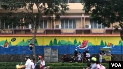FILE - Children get picked up to go home after school in Ho Chi Minh City, Vietnam.