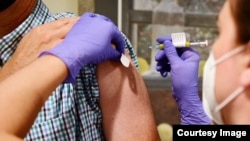 FILE - This undated file photo from Johnson & Johnson shows an experimental COVID-19 vaccine study undergoing late stage trials. The drug-maker announced Oct. 12 that it temporarily suspended the trials after an "unexplained illness." (Johnson & Johnson)