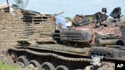 FILE - Tanks destroyed during fighting between forces of Salva Kiir and Riek Machar, on July 10, 2016 in Jabel area of Juba, South Sudan.