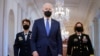 President Joe Biden walks with Air Force Gen. Jacqueline Van Ovost, left, and Army Lt. Gen. Laura Richardson before speaking at an event to mark International Women's Day, March 8, 2021, in the East Room of the White House in Washington.